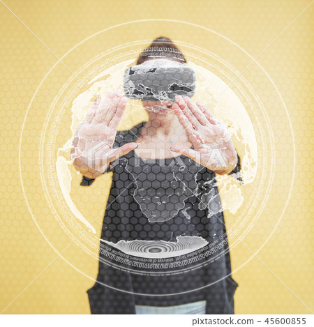 Happy woman in the studio gets the experience of using VR-glasses virtual reality headset 45600855