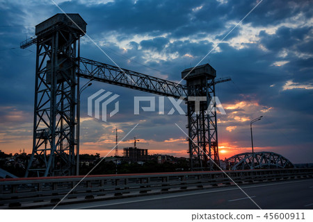 View of modern concrete bridge over river at sunset 45600911