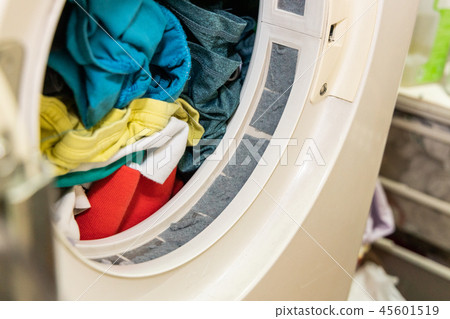 Lint trapped in filter of laundry dryer machine Lint trapped in filter of laundry dryer machine 45601519