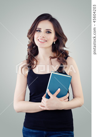 Happy girl with book. Young woman student smiling Happy girl with book. Young woman student smiling 45604203