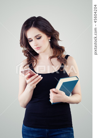 Cute student woman with smartphone texting. Cute student woman with smartphone texting. 45604204
