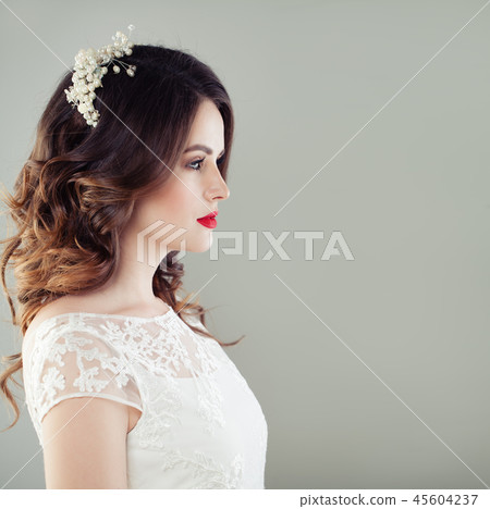 Charming young woman bride with wavy hairstyle Charming young woman bride with wavy hairstyle 45604237