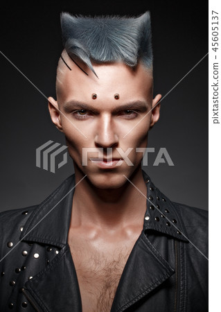 Young man with blue hair and creative makeup and hair. 45605137