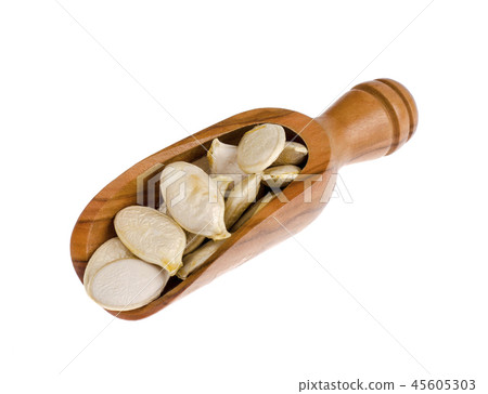 Dry pumpkin seeds in wooden scoop, isolated on white background Dry pumpkin seeds in wooden scoop, isolated on white background 45605303