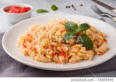 Spiral pasta mixed with cherry tomatoes and tomato 45605649