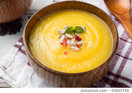 Pumpkin soup mashed with spices in wooden bowls  45605748