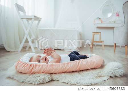 Bedding for children. The baby sleeps in bed. A healthy little baby soon after birth. Bedding for children. The baby sleeps in bed. A healthy little baby soon after birth. 45605883