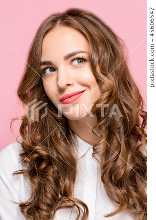 The happy business woman standing and smiling against pink background. The happy business woman standing and smiling against pink background. 45606547