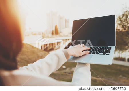 A young girl looks at information on a laptop 45607730