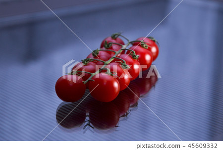bunch of red cherry tomatoes on a plate 45609332