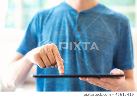 Young man with a tablet computer 45613419