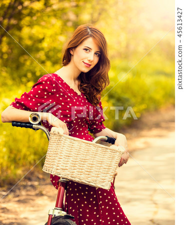 girl with bike at rural road in a park girl with bike at rural road in a park 45613427