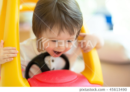 Happy toddler boy playing in his toy car 45613490