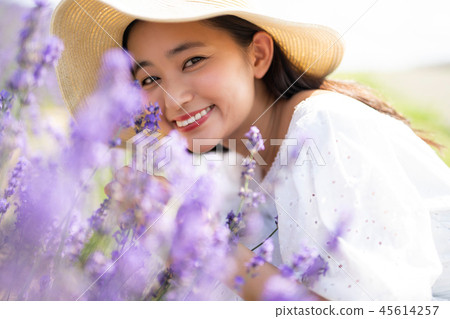 Flower field and woman portrait 45614257