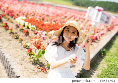 Flower field and woman portrait 45614293