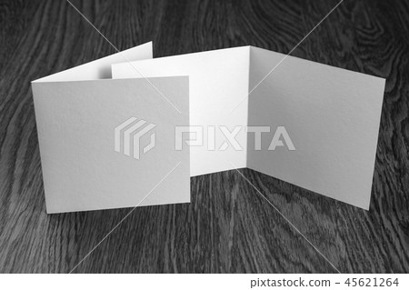 Mockup of white booklet on wooden background. Mockup of white booklet on wooden background. 45621264