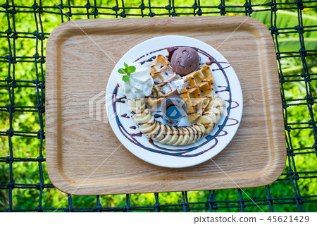 Waffles, bananas and chocolate ice cream  45621429