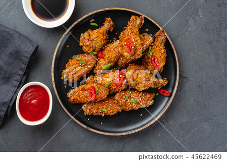 Chicken nuggets with sauce and pepper on a dark background. Copy space. 45622469