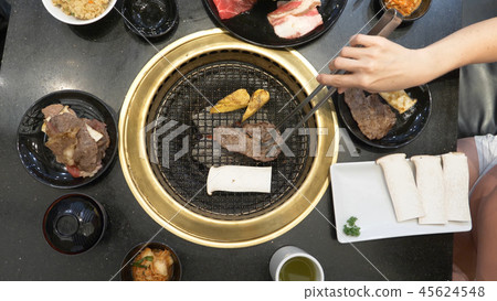 Korean barbecue grill. people cook and eat dishes cooked on a Korean grill in a restaurant. close-up 45624548