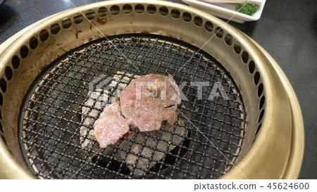 Korean barbecue grill. people cook and eat dishes cooked on a Korean grill in a restaurant. close-up Korean barbecue grill. people cook and eat dishes cooked on a Korean grill in a restaurant. close-up 45624600