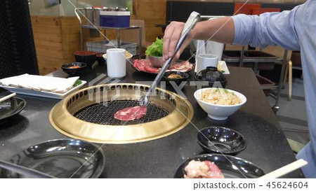 Korean barbecue grill. people cook and eat dishes cooked on a Korean grill in a restaurant. close-up 45624604