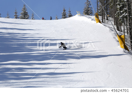 Unrecognized man going down on ski slope Unrecognized man going down on ski slope 45624701
