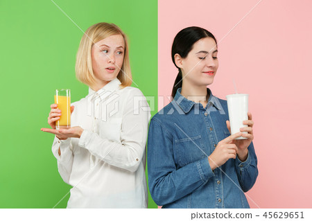 Diet. Dieting concept. Healthy Food. Beautiful Young Women choosing between fruit orange juice and Diet. Dieting concept. Healthy Food. Beautiful Young Women choosing between fruit orange juice and 45629651