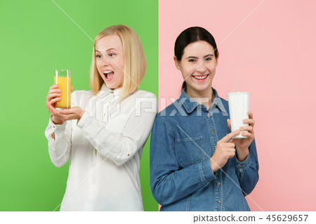 Diet. Dieting concept. Healthy Food. Beautiful Young Women choosing between fruit orange juice and Diet. Dieting concept. Healthy Food. Beautiful Young Women choosing between fruit orange juice and 45629657