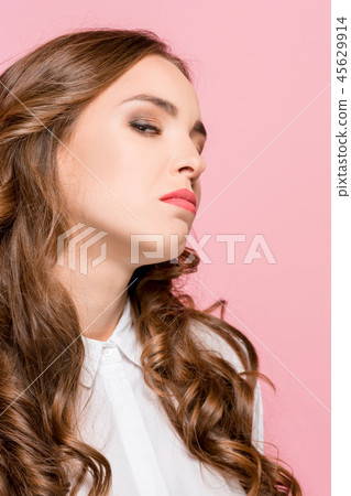 Portrait of young woman arrogantly looking in camera isolated 45629914