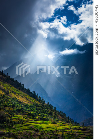 Sun rays through clouds in Himalayan valley in Himalayas 45630445