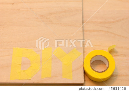 "DIY" written on a wooden board with masking tape. "DIY" written on a wooden board with masking tape. 45631426