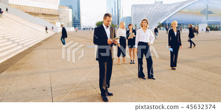 Businesswoman from back passing in with blue document case in Businesswoman from back passing in with blue document case in 45632374