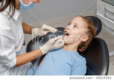 Child having dental check up by specialist Child having dental check up by specialist 45633593