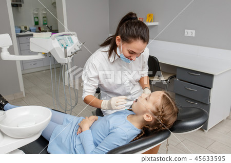 Child having dental check up by specialist Child having dental check up by specialist 45633595