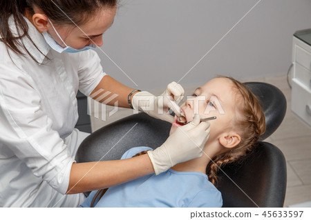 Child having dental check up by specialist Child having dental check up by specialist 45633597