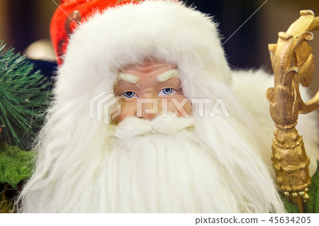 Santa Claus with gifts sitting next to a Christmas tree Santa Claus with gifts sitting next to a Christmas tree 45634205