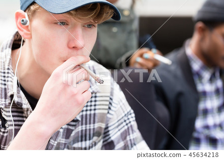 Portrait of young boy smoking Portrait of young boy smoking 45634218