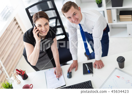 Young people in the office looking at the monitor. 45634423