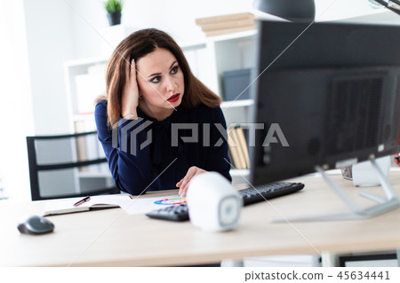 A young girl working with documents on the computer. 45634441