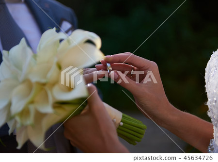 Bride and groom exchanging rings close up 45634726