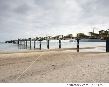 Tourists walk on sandy beach, enjoy view  45637590