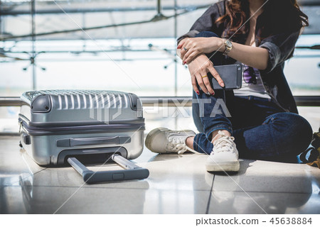 Close up of young woman with bag and suitcase luggage waiting fo Close up of young woman with bag and suitcase luggage waiting fo 45638884