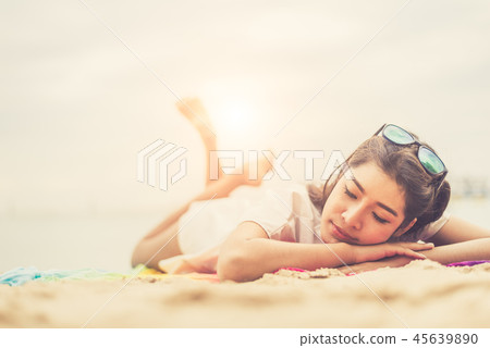 Beauty woman lying on beach. Sea and ocean background People and Beauty woman lying on beach. Sea and ocean background People and 45639890