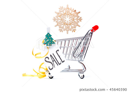 Photo of iron cart, Christmas tree, card with inscription, wooden snowflake Photo of iron cart, Christmas tree, card with inscription, wooden snowflake 45640390
