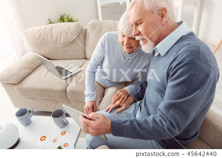 Beautiful couple of mature entrepreneurs looking involved 45642440