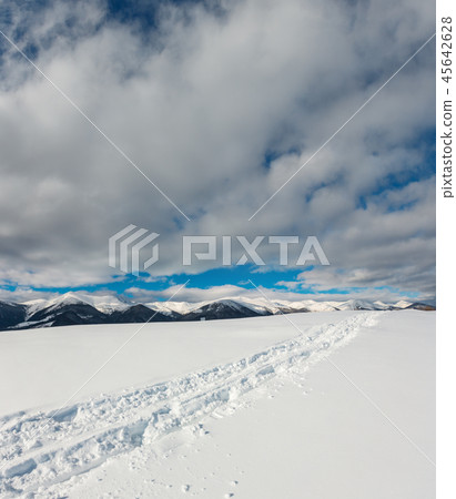 Sledge trace and footprints on winter mountain Sledge trace and footprints on winter mountain 45642628
