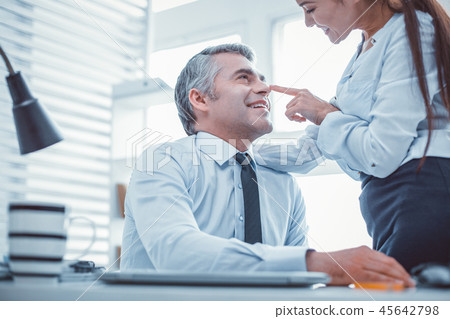 Female worker touching nose of her superior Female worker touching nose of her superior 45642798