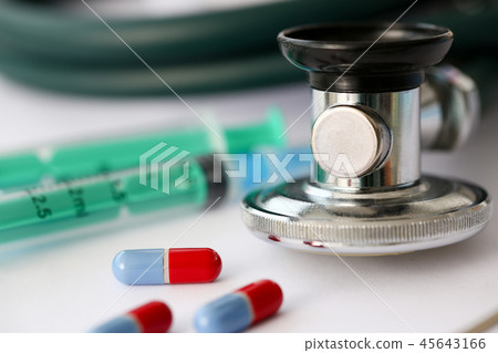 Stethoscope pile of pills fall out from jar to paper Stethoscope pile of pills fall out from jar to paper 45643166