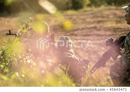 Sniper team armed with large caliber, sniper rifle, shooting enemy targets on range from shelter 45643471