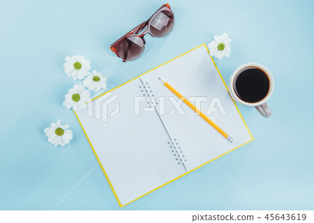 On the blue background notebook pencil, ruler and white flowers 45643619